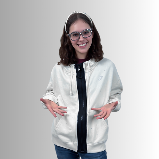 Person wearing a white jacket with a black zipper on a gray background